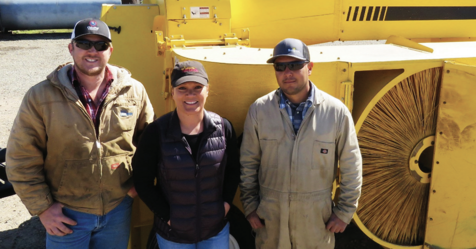 Pitts (center) and field supervisors Ben Tickenoff (left) and Javier Maldonado (right) stand with their new low-dust harvester.